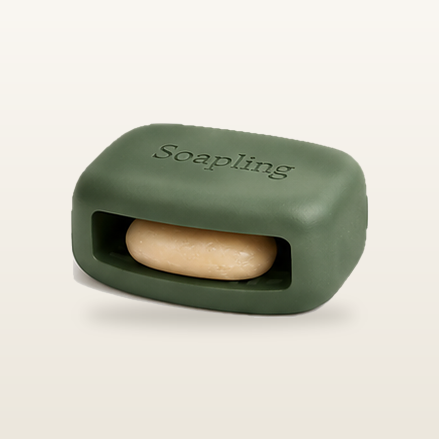 The Soapling bar in Sage Deep with a soap sliver tucked into its side pocket
